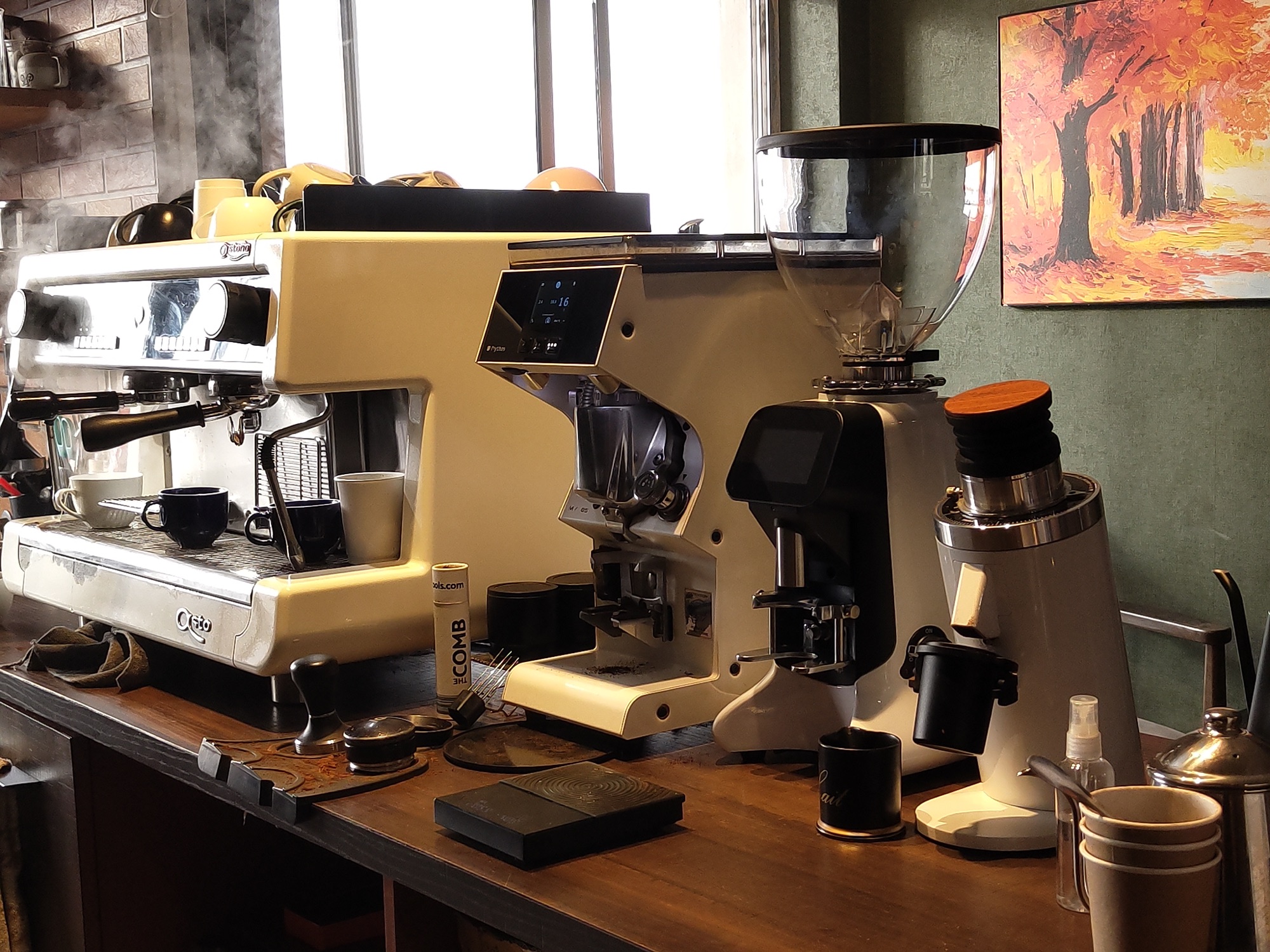The espresso machine and grinders steaming on the Autumn Brew bar in Aizawl